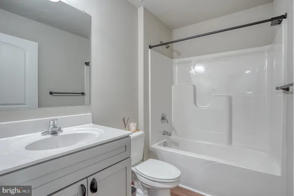 a bathroom with a sink toilet tub and shower