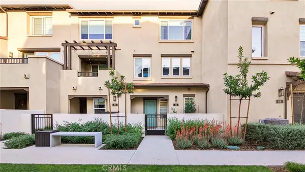 a front view of multiple houses with yard