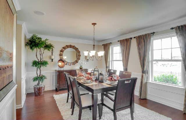1406 Old Stone Road, Unit 443 Lebanon, TN 37087 - Photo 8 of 24 a dining room with furniture a potted plant and a chandelier