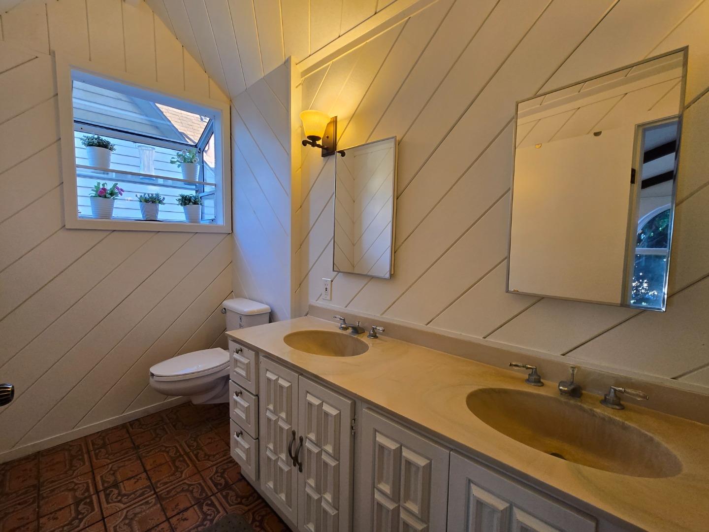 131 Hazel Avenue Millbrae, CA 94030 - Photo 4 of 19 a bathroom with a double vanity sink and a mirror