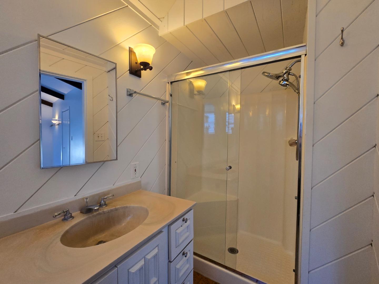 131 Hazel Avenue Millbrae, CA 94030 - Photo 5 of 19 a bathroom with a shower sink and mirror