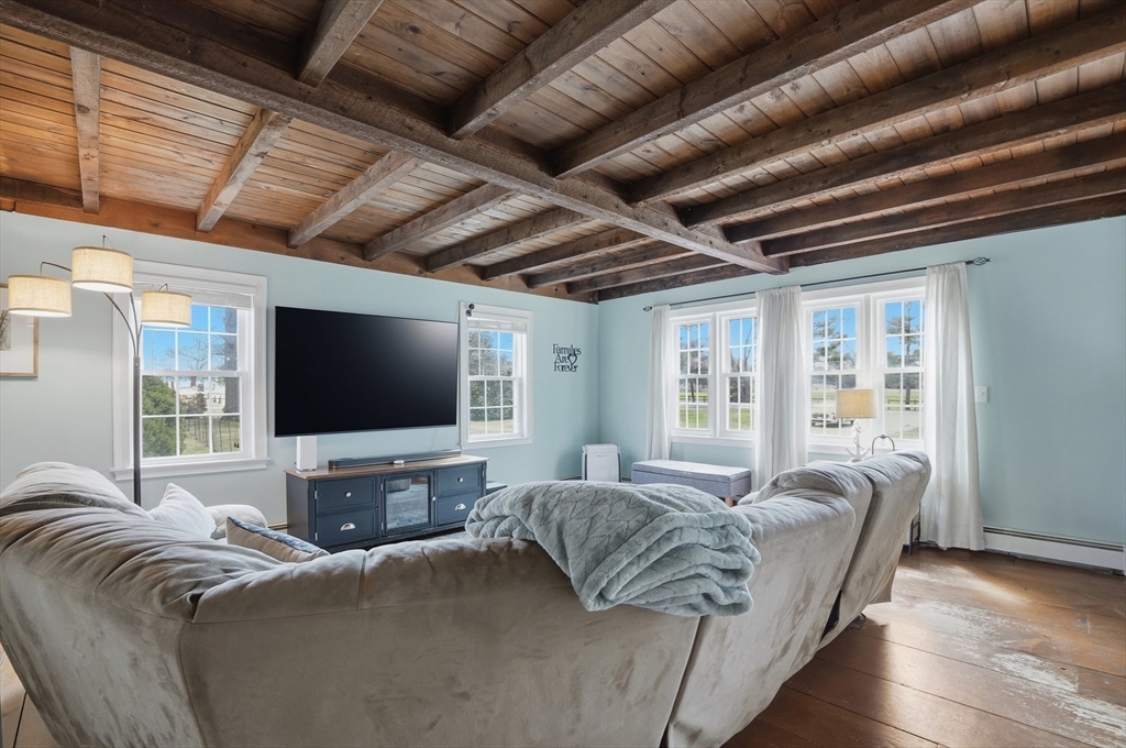 61 Main Street Hanover, MA 02339 - Photo 7 of 38 a living room with furniture and a flat screen tv