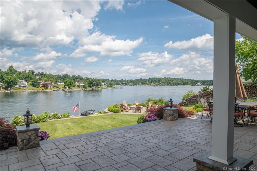 a view of a lake with couches chairs