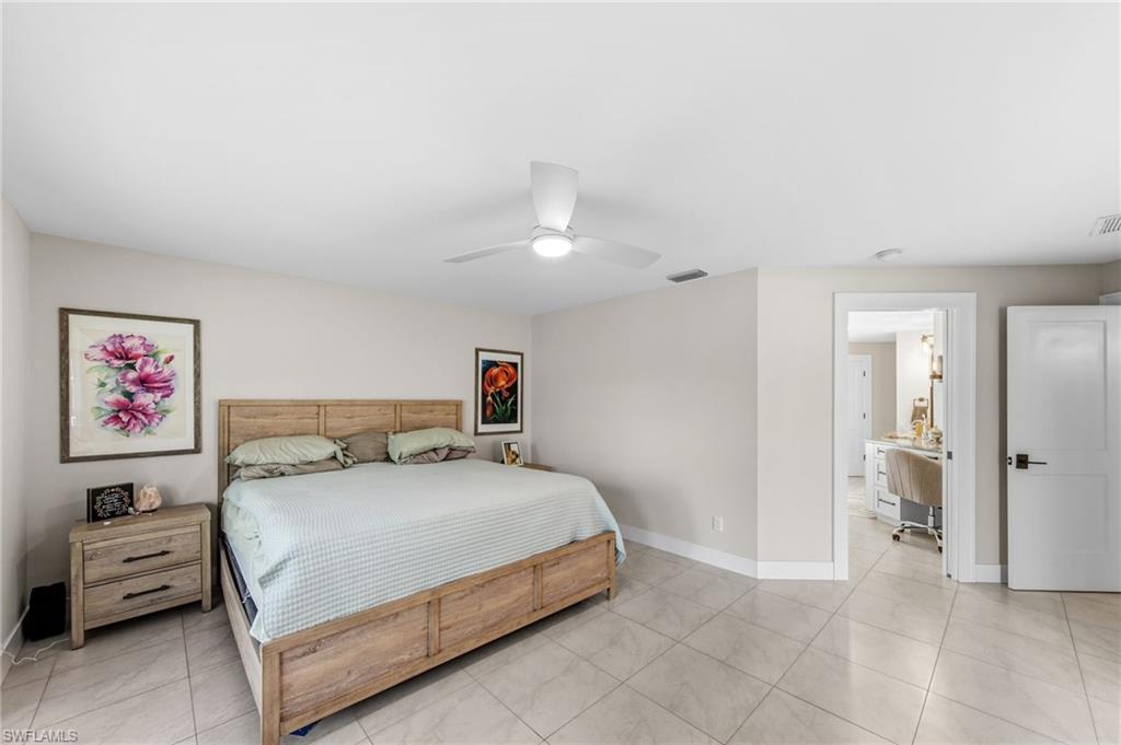 4724 Riverside Drive Estero, FL 33928 - Photo 15 of 44 a bedroom with a bed and a refrigerator