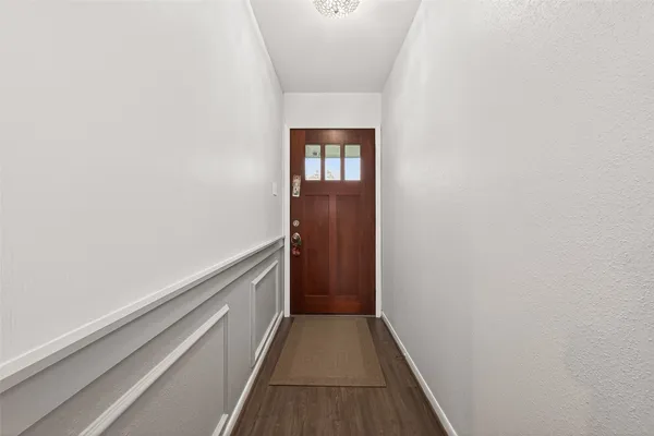 a dining room with furniture and wooden floor