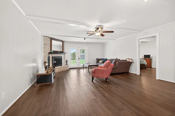 a living room with furniture a fireplace and a flat screen tv