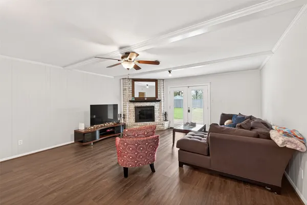 a living room with furniture a flat screen tv and a fireplace