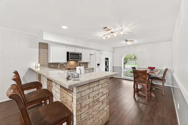 a living room with furniture and kitchen view