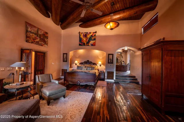 a living room with patio furniture and a floor to ceiling window