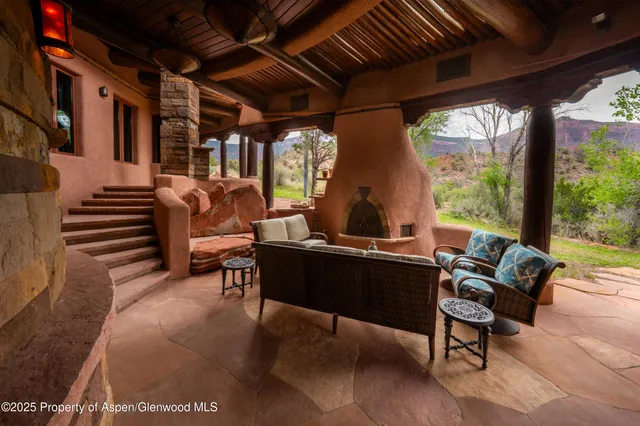 a living room filled with furniture and a floor to ceiling window