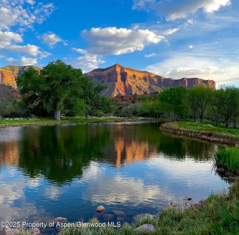 an aerial view of a house with garden space and street view