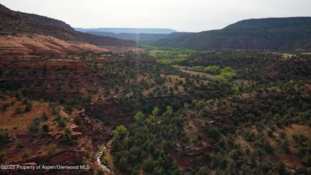 a view of a lake with a table and chairs