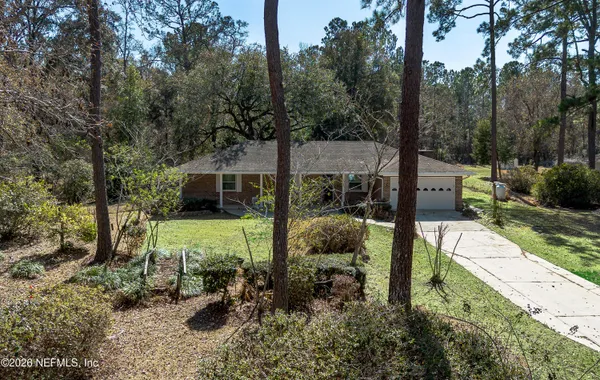 a view of backyard with swimming pool and seating space