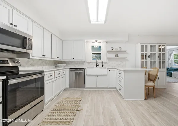a kitchen with a sink stove and cabinets