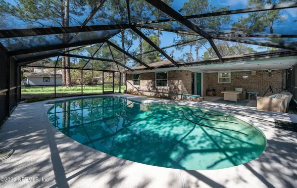 a view of a swimming pool with a patio