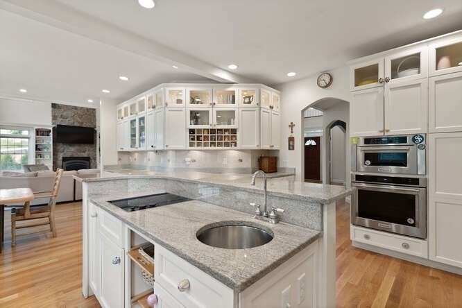 343 Bay Road Hamilton, MA 01982 - Photo 13 of 34 a kitchen with stainless steel appliances granite countertop a sink and a refrigerator