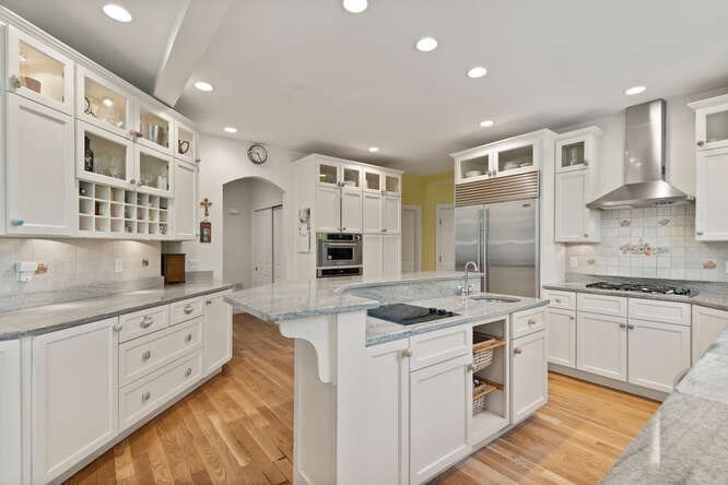 343 Bay Road Hamilton, MA 01982 - Photo 15 of 34 a kitchen that has a lot of cabinets in it and wooden floors
