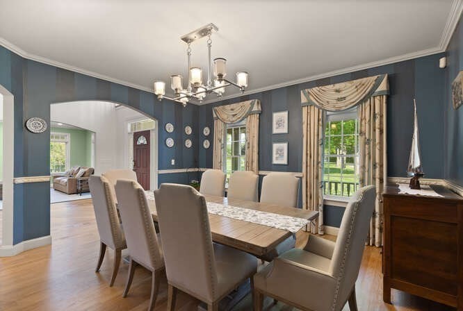 343 Bay Road Hamilton, MA 01982 - Photo 17 of 34 a view of a dining room with furniture a chandelier and wooden floor