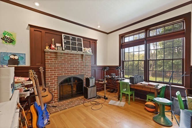343 Bay Road Hamilton, MA 01982 - Photo 20 of 34 a living room with furniture a fireplace and floor to ceiling window