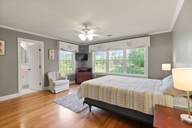 343 Bay Road Hamilton, MA 01982 - Photo 26 of 34 a bedroom with a large bed and a chandelier