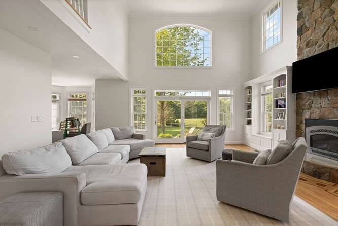 343 Bay Road Hamilton, MA 01982 - Photo 9 of 34 a living room with furniture large window and flat screen tv