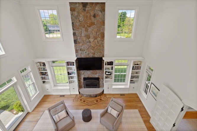 343 Bay Road Hamilton, MA 01982 - Photo 10 of 34 a living room with furniture a flat screen tv and a fireplace