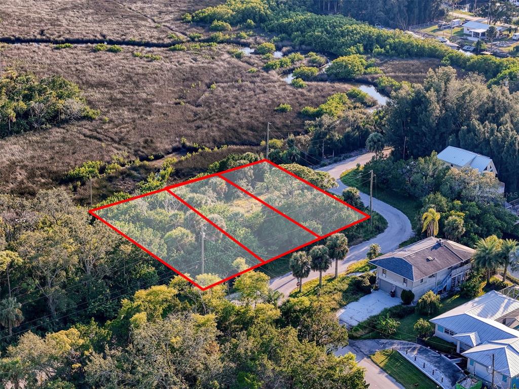 12 Nowiki Avenue Hudson, FL 34667 - Photo 11 of 20 an aerial view of a tennis ground and a houses