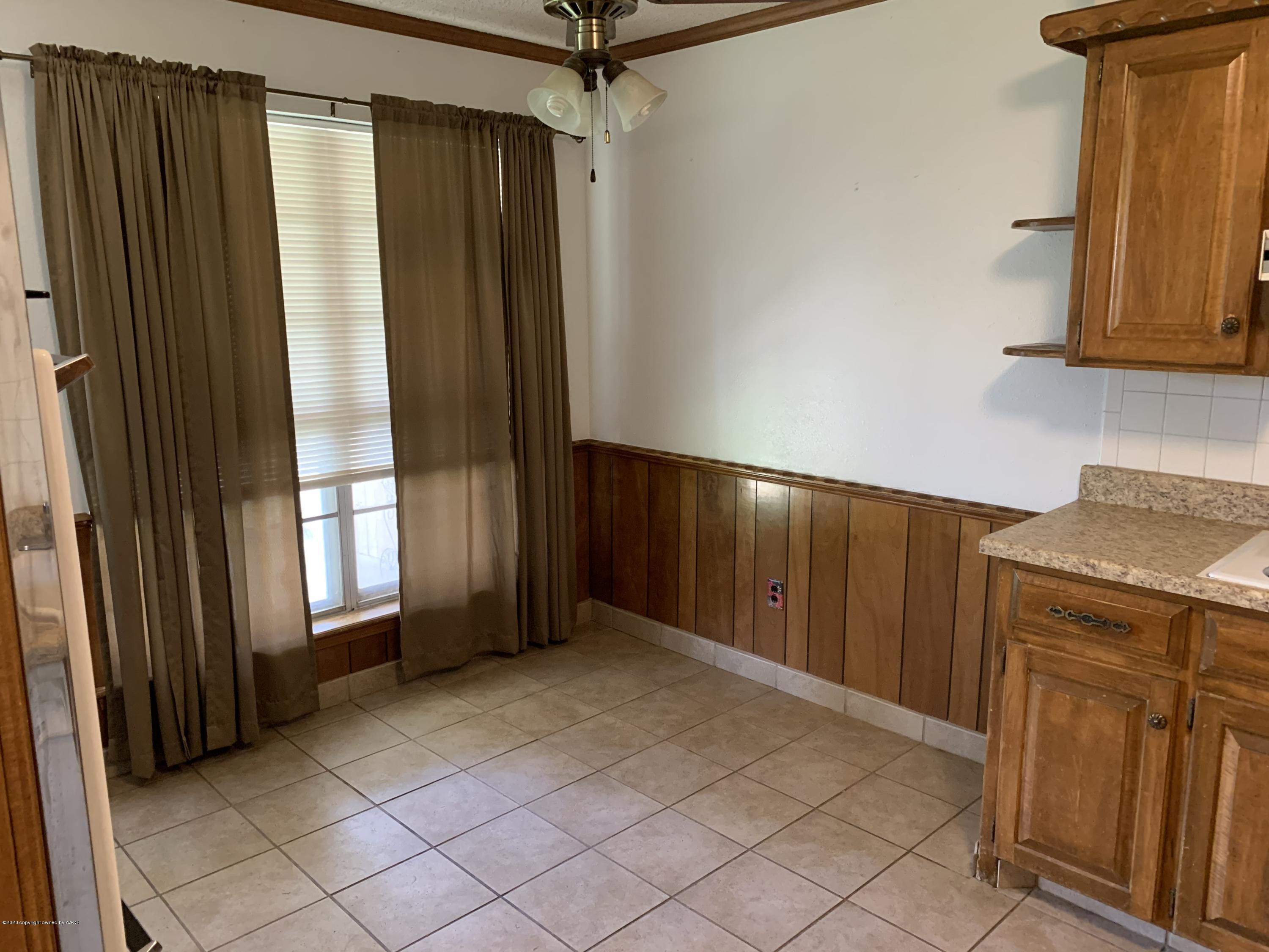 4406 Ridgecrest Circle Amarillo, TX 79109 - Photo 6 of 12 a view of an empty room with wooden floor and a window