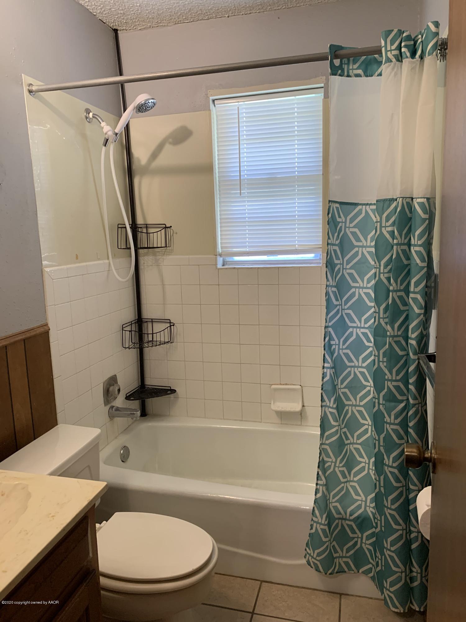 4406 Ridgecrest Circle Amarillo, TX 79109 - Photo 10 of 12 a bathroom with a sink a toilet and shower