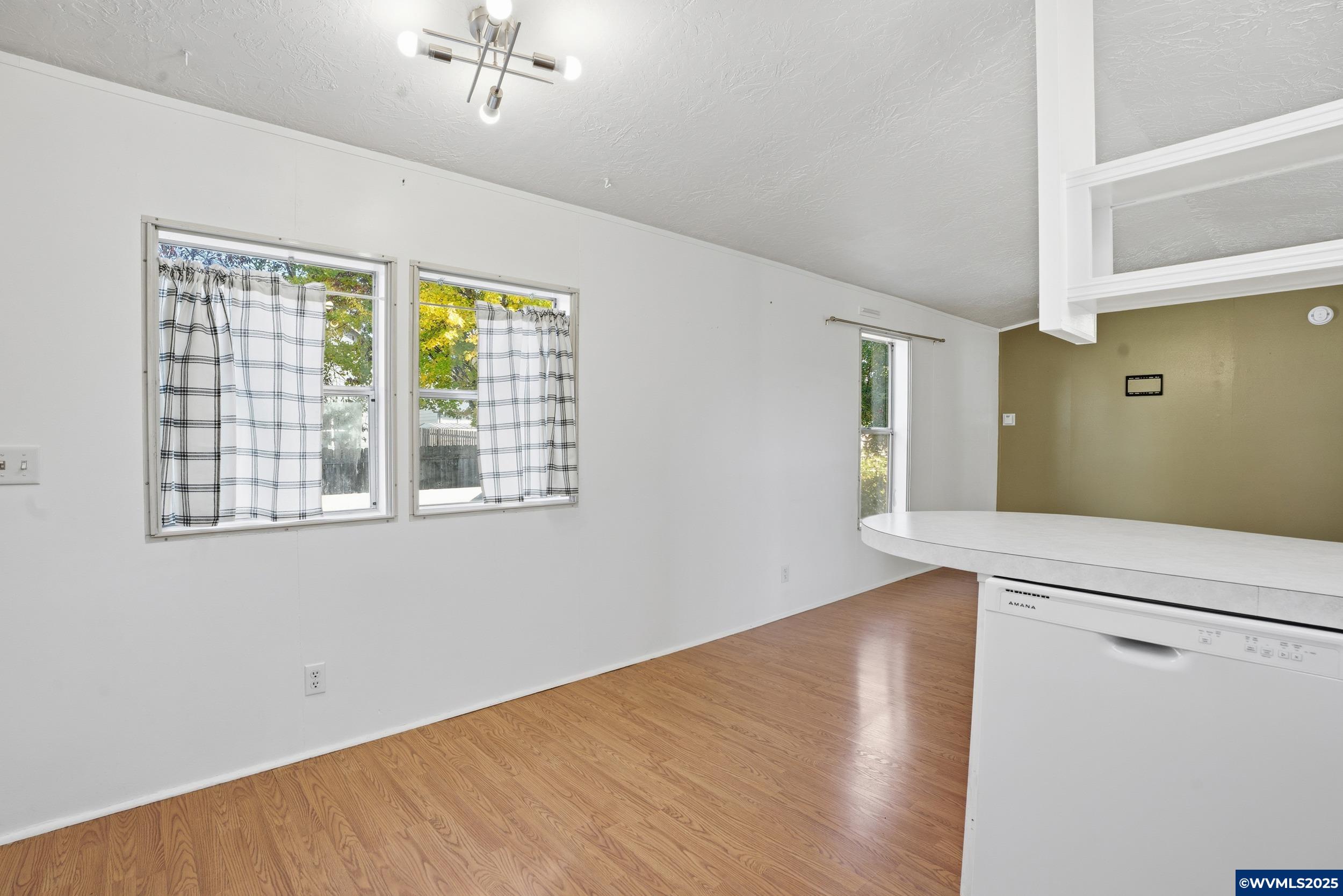 277 Edwards Road, Unit 145 Monmouth, OR 97361 - Photo 9 of 47 a view of a livingroom with wooden floor and a window