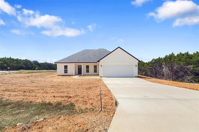 a house with yard and wooden fence