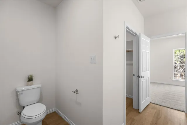 a white toilet sitting next to a bathroom sink