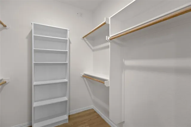 a view of walk in closet with empty racks