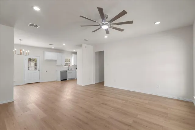 a view of a kitchen with a sink and a refrigerator