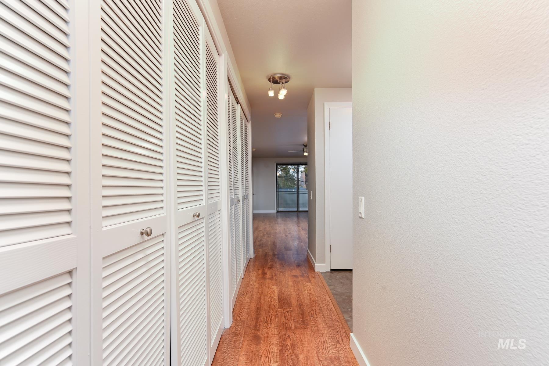 7208 West Cascade Street Boise, ID 83704 - Photo 32 of 49 Corridor featuring light wood-style flooring and a textured wall