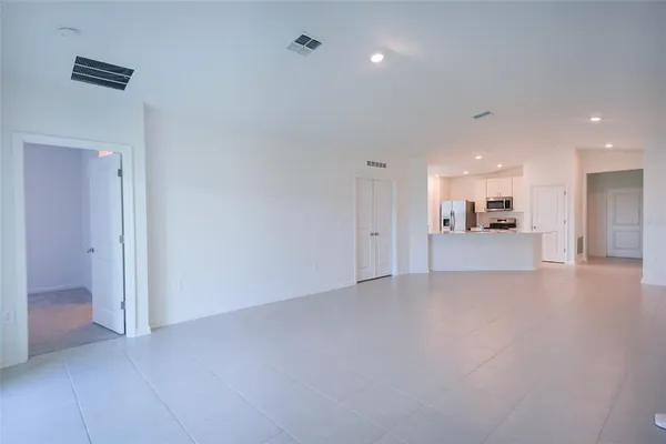 a view of a big room with closet and windows