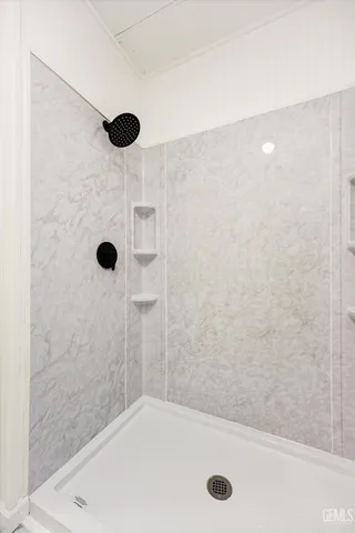 a bathroom with a tub and a shower