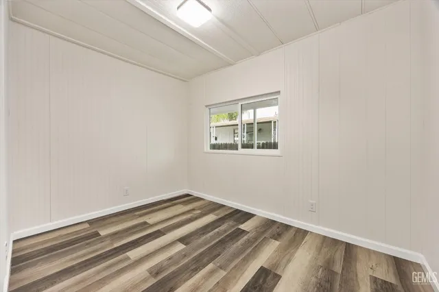 a view of a room with wooden floor and window