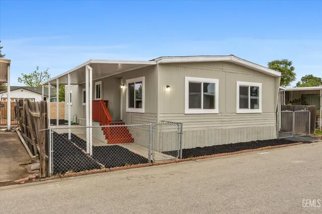 a view of a house with wooden fence