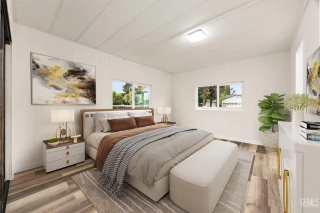 a bed room with a bed and a painting on the wall