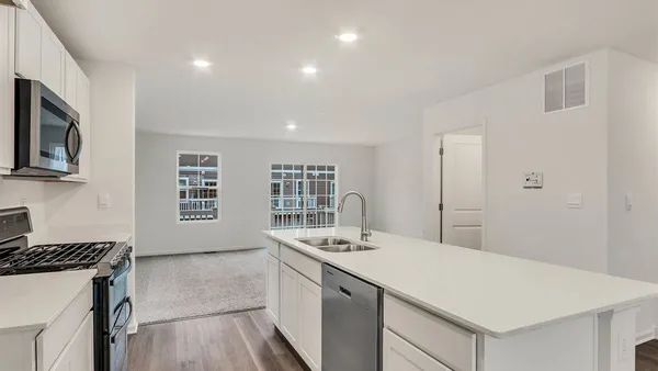 a kitchen with a sink a stove and microwave