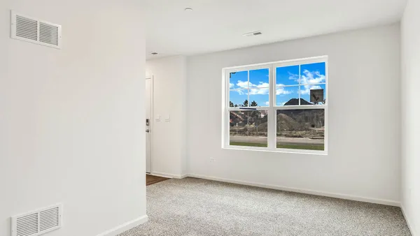 a kitchen with stainless steel appliances a stove a microwave and white cabinets