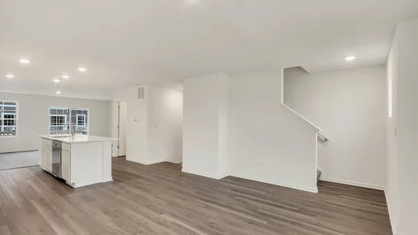 a kitchen with cabinets and wooden floor