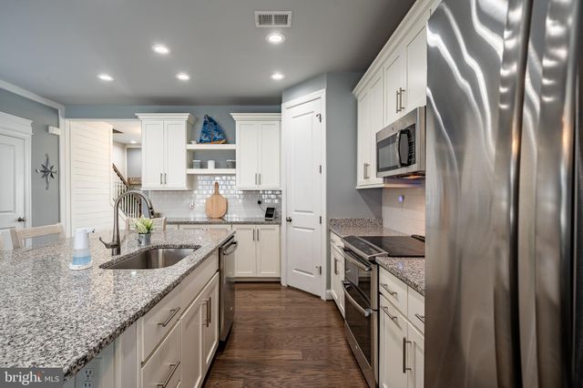 a dining room with furniture potted plants and wooden floor