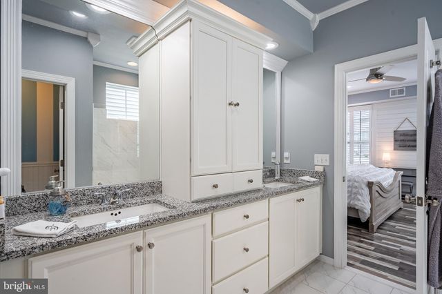 a patio with a table and chairs and potted plants