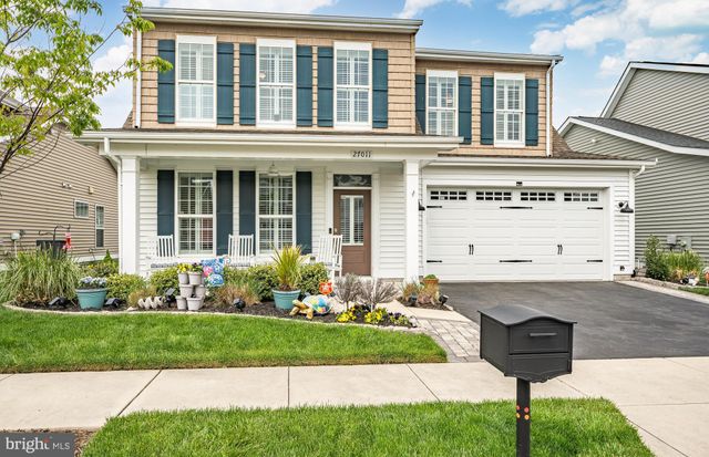 a view of a chairs and table in patio with a barbeque