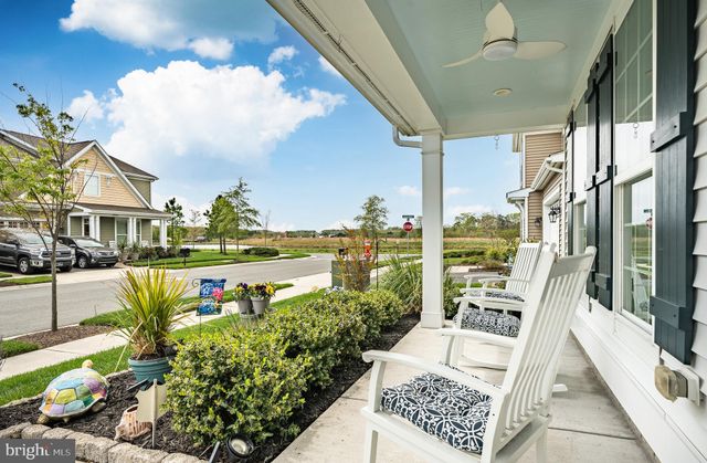 a living room with furniture and flowers
