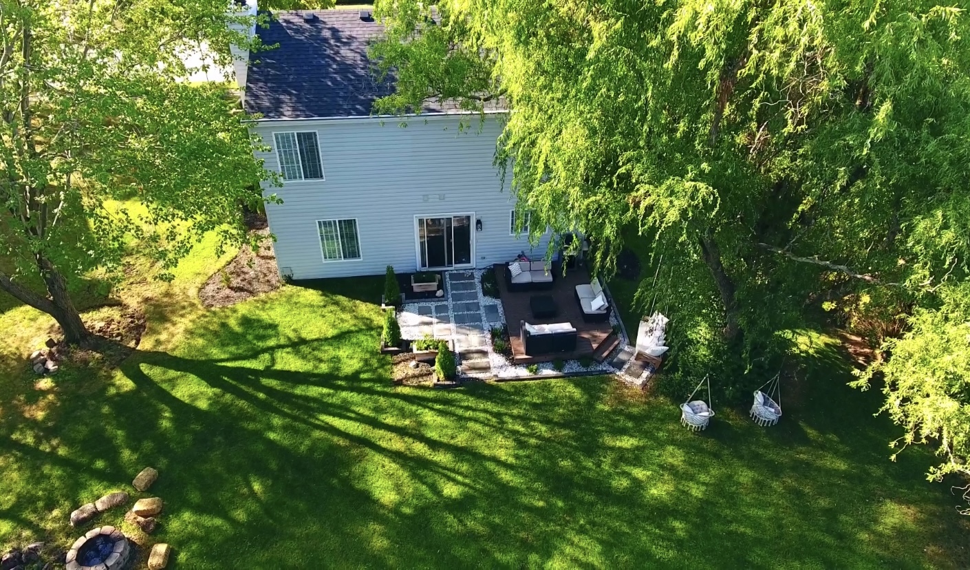 1407 Canyon Run Road Naperville, IL 60565 - Photo 21 of 22 a backyard of a house with table and chairs and a large tree