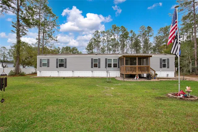 a view of a house with a backyard porch and sitting area