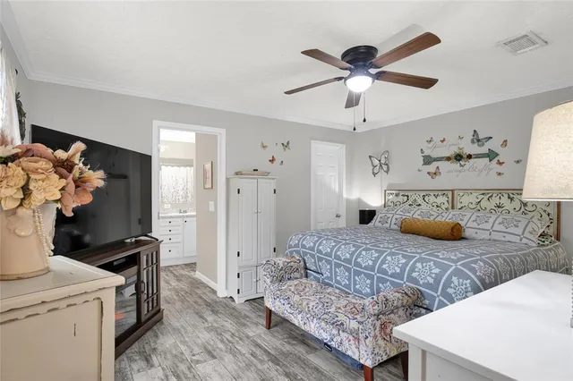 a bedroom with a bed and a chandelier